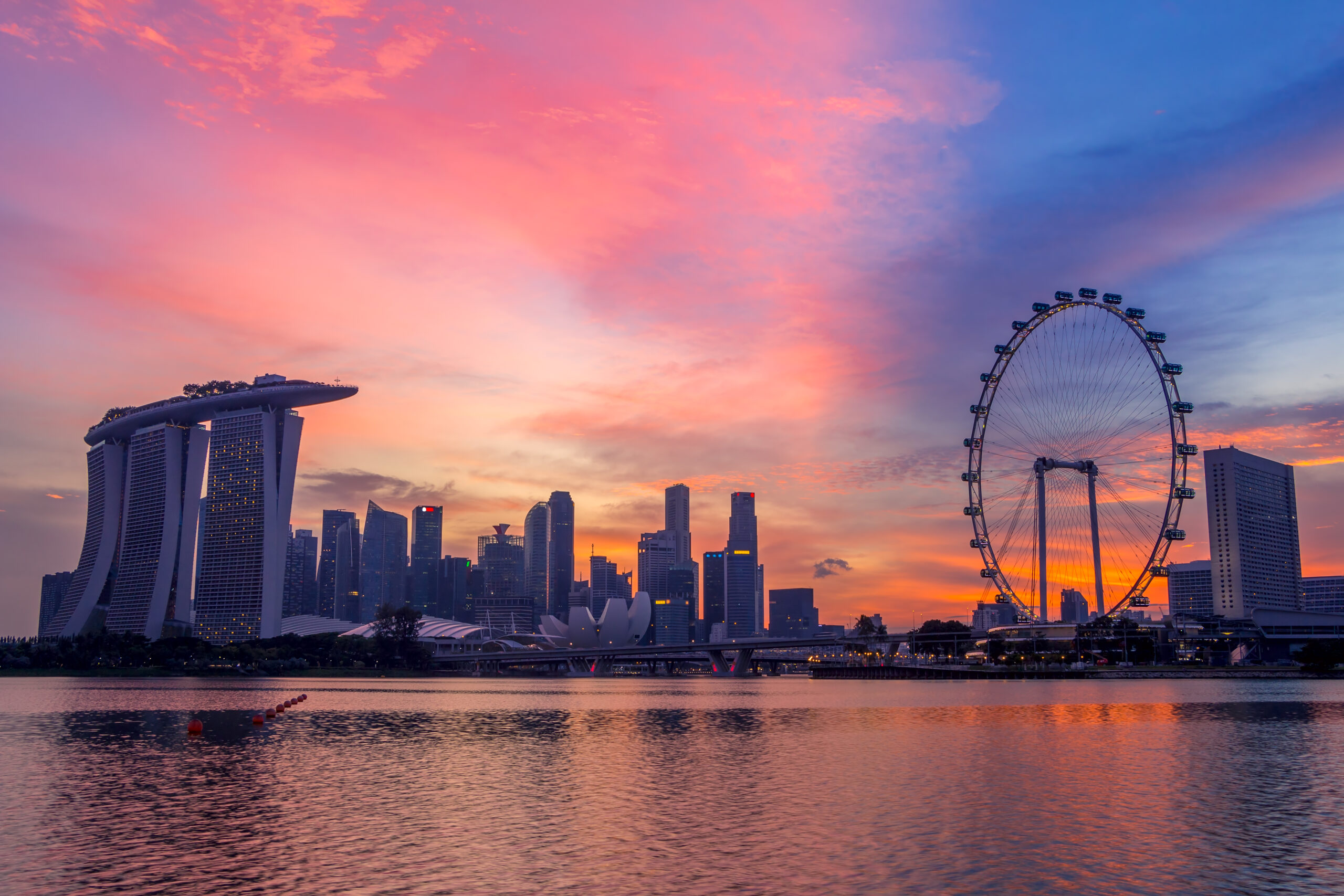 Sunset in Singapore. Skyscrapers and main showplaces Singapore Flyer, Marina Bay Sands, Art Science Museum